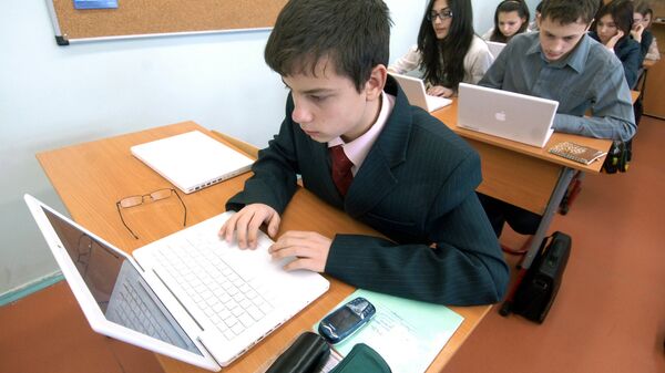 Школьники работают с ноутбуками в классе. Архивное фото